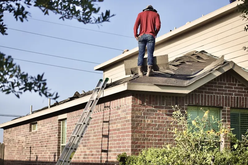 Professional roofer working on a residential roof in Fairway Bend